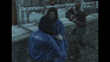 a blurry picture of a man in a blue shirt standing in front of a window .