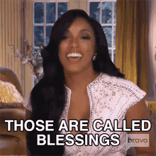 a woman says " those are called blessings " in front of a window