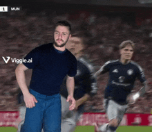a man in a blue shirt is standing in front of a blurred image of soccer players with the number 1 mun on the bottom