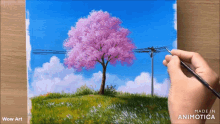 a painting of a cherry blossom tree is being made by wow art
