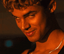 a close up of a man with a necklace around his neck