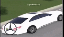 a white mercedes is driving down the road