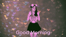 a girl in a pink shirt says good morning in front of hearts