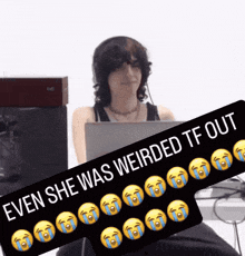 a woman sitting at a desk with a laptop and a sign that says even she was weirded tf out