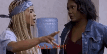 two women are talking to each other and the words wait what are visible