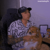 a man wearing headphones holds a small dog in his lap with the caption imantadogifs above him