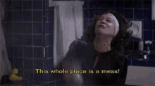 a woman in a bathroom with the words this whole place is a mess