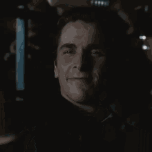 a close up of a man 's face with a slight smile on his face