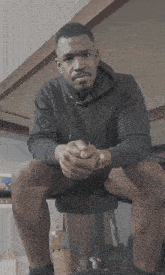 a man wearing a black sweatshirt with the word nike on it