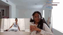 a woman wearing headphones sits in a chair in front of a window