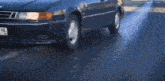 a black car with a license plate that reads y 571 cx 98