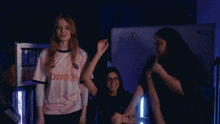 a girl wearing a shirt that says ' e ' on it