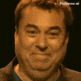 a man in a suit and blue shirt is making a funny face with his mouth open .