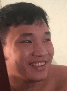 a close up of a man 's face smiling