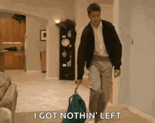 a man is walking with a suitcase and says i got nothin left