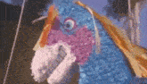 a close up of a blue and pink piñata with a bunny face .