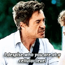 a man in a white shirt is talking to another man and says i despise who you are at a cellular level .