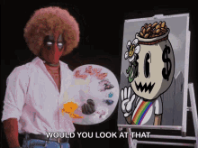 a man in a deadpool mask is holding a palette next to a painting of a cartoon character