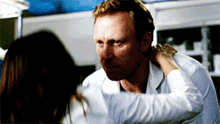 a man in a lab coat is being held by a woman