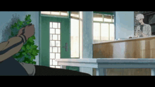 a man is standing in front of a counter in a room with a green door