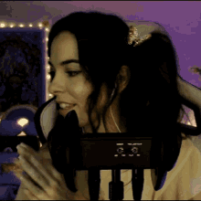 a woman sitting in a chair with a microphone in front of her face