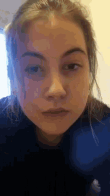 a close up of a young girl 's face with a blurred background