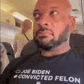 a man wearing a shirt that says " joe biden convicted felon "