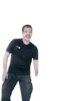 a man wearing a black nike shirt is dancing with his arms outstretched