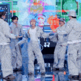 a group of people are dancing in front of a screen that says j.r.