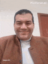 a man in a brown jacket is smiling in front of a galaxy a23 phone