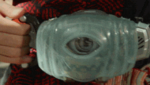 a person is holding a clear object that looks like an eye with the number 6 on it