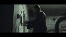a man in a suit is reaching into a locker