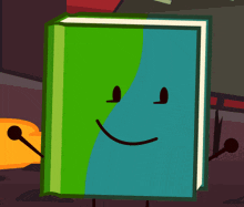 a green and blue book with a smiley face
