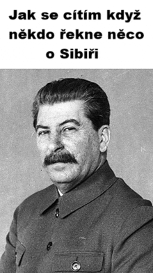 a black and white photo of a man with a mustache and a foreign language caption .