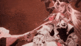 a woman with horns and a sword is laying down