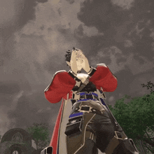 a man in a red jacket stands in front of a cloudy sky with his hands up