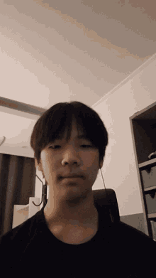 a young man taking a picture of himself in a bedroom