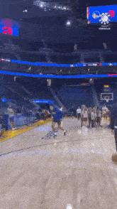 a group of people are standing on a basketball court in front of an oracle sign .