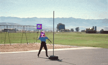 a person standing next to a pole with a sign that says " no parking " on it