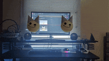 a desk with a computer monitor and two balloons with smiley faces on them