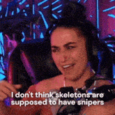 a woman wearing headphones says i don 't think skeletons are supposed to have snipers ..