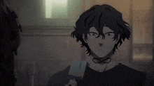 a person with black hair is holding an ice cream bar