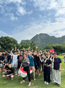 a group of people are posing for a picture and one of them is wearing a shirt that says ' tokyo ' on it