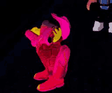 a cartoon character in a pink outfit is talking on a cell phone in a dark room .