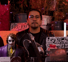 a man wearing glasses stands in front of a sign that says foxc on it