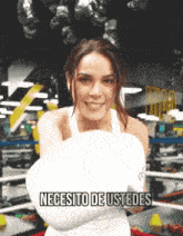 a woman wearing boxing gloves with the words necesito de ustedes above her