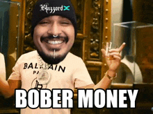 a man wearing a beanie and a balmain shirt says bober money in white letters