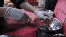 a person is cutting a piece of meat with a knife and the words made in animotica are on the bottom