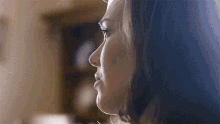a close up of a woman 's face in a room .
