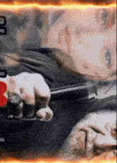 a close up of a person holding a gun with a heart in the background